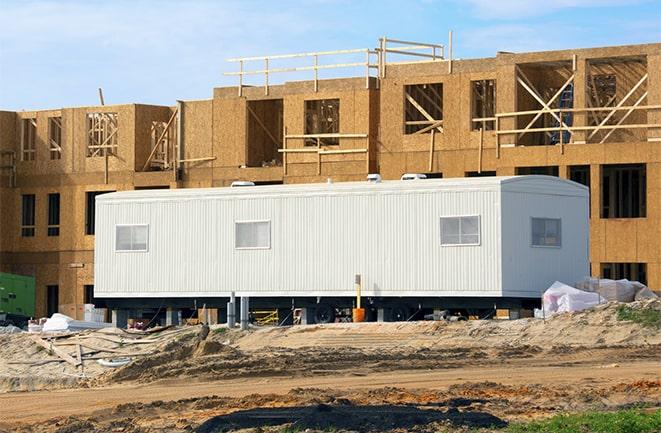 crane lifting modular building for construction office rentals in Hazel Park